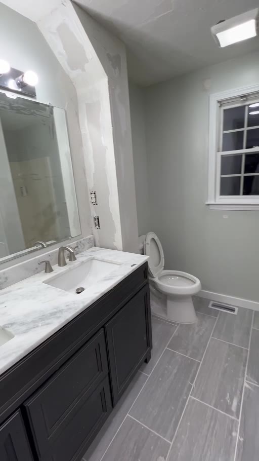 Bathroom renovation after new tile, vanity, and fixtures